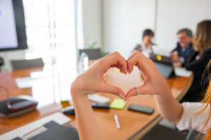 Woman makes a heart with her hands